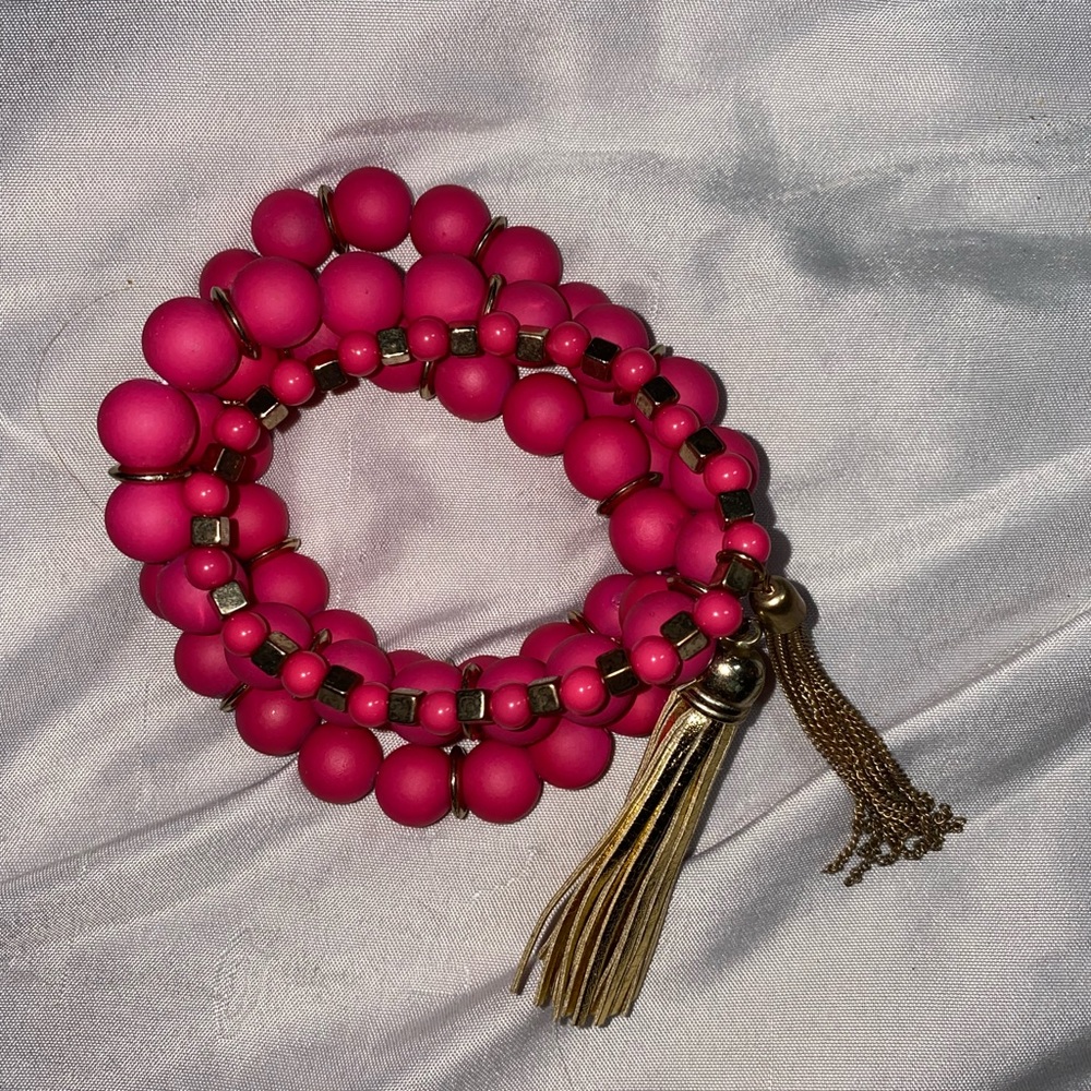 4 piece hot pink bracelet set with gold tassels and trim.